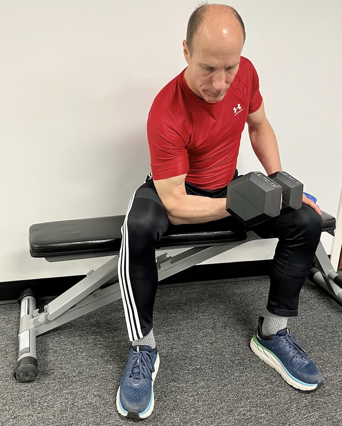 Man training with a weight at an indoor gym.